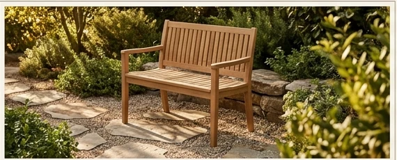 Wooden outdoor garden bench pictured in warm evening sunlight